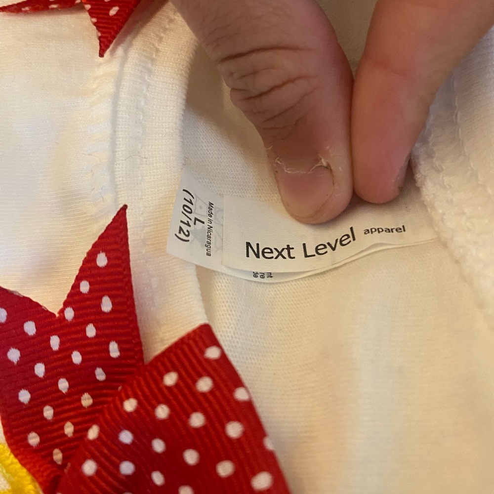 A Mickey Mouse shirt with M on front. This is a kids large - Picture 2 of 4